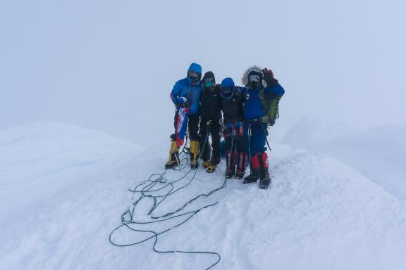 Group photo in whiteout conditions, on the summit of Mount Sidley.